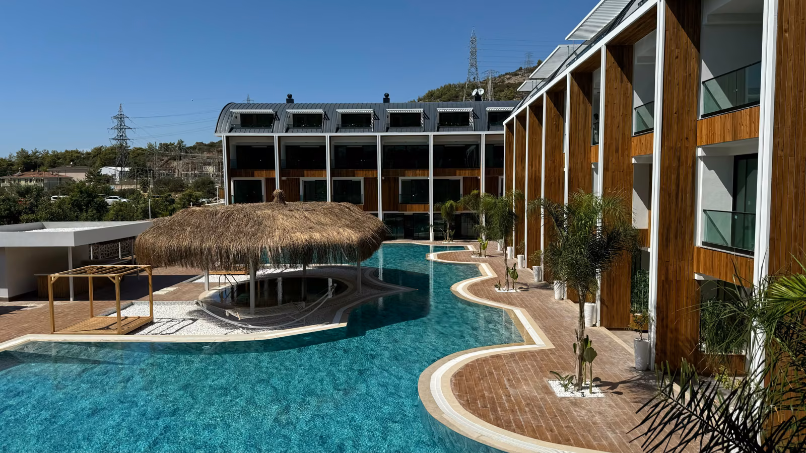 Residential blocks around an outdoor pool and shaded island seating