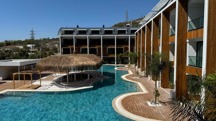 Residential blocks around an outdoor pool and shaded island seating