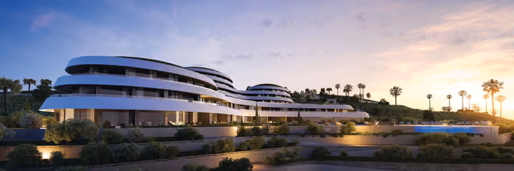 Architectural visualization of the apartment blocks and landscaped seafront in warm evening light.