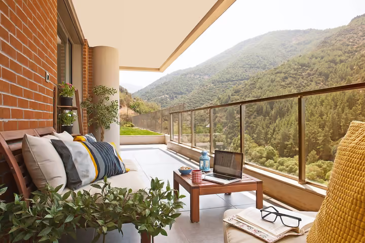 Furnished balcony facing the wooded hillside.