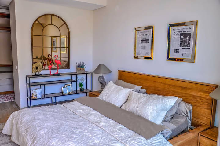 Furnished bedroom with a large window.