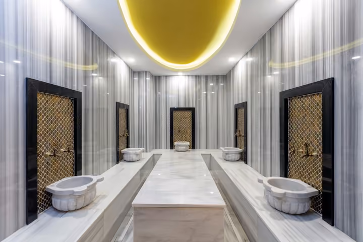 Photograph of turkish bath with marble basins.