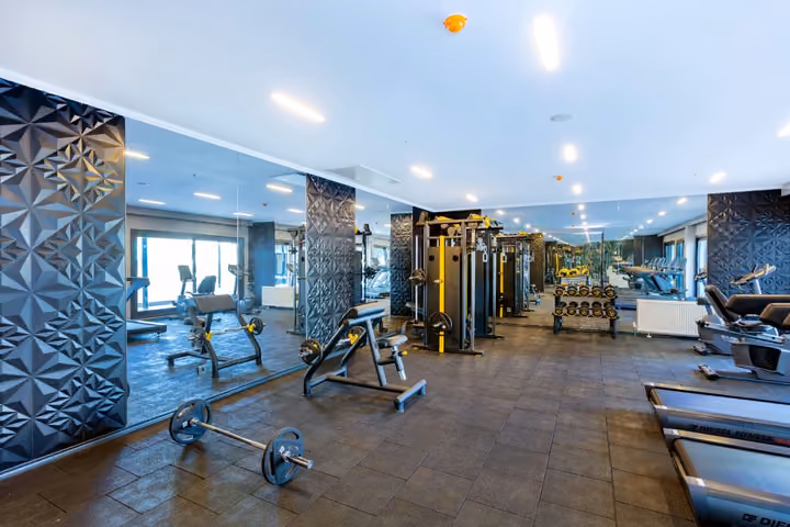 Photograph of gym with strength-training equipment.