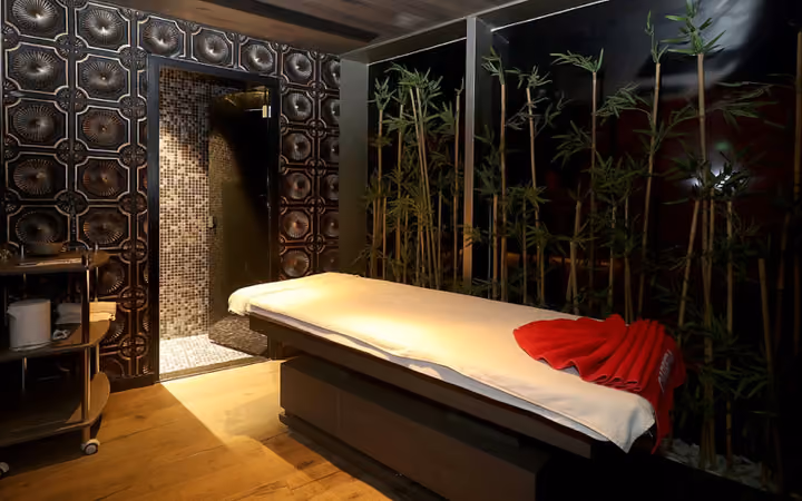 Spa treatment room with massage bed.
