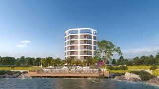 Architectural rendering of the building and waterfront deck from the sea
