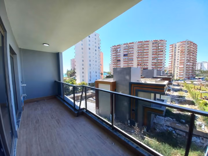 A show apartment balcony photographed toward the surrounding neighborhood.