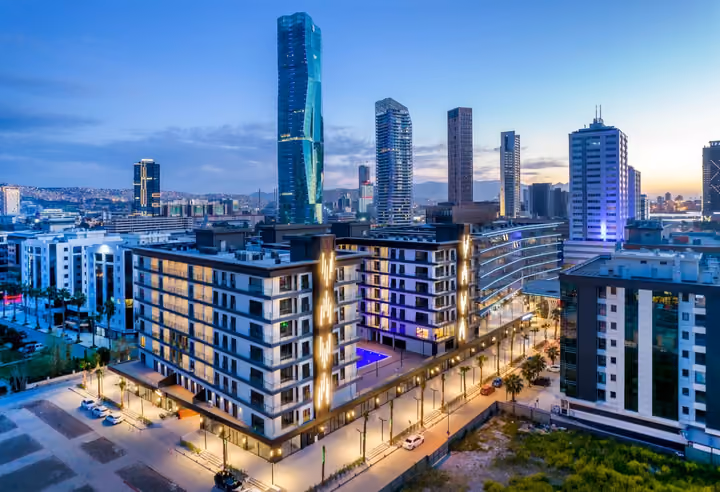 Photograph of residential courtyard and Bayrakli skyline.