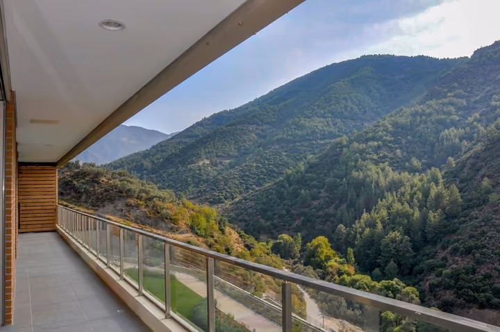 Long balcony overlooking the wooded valley.