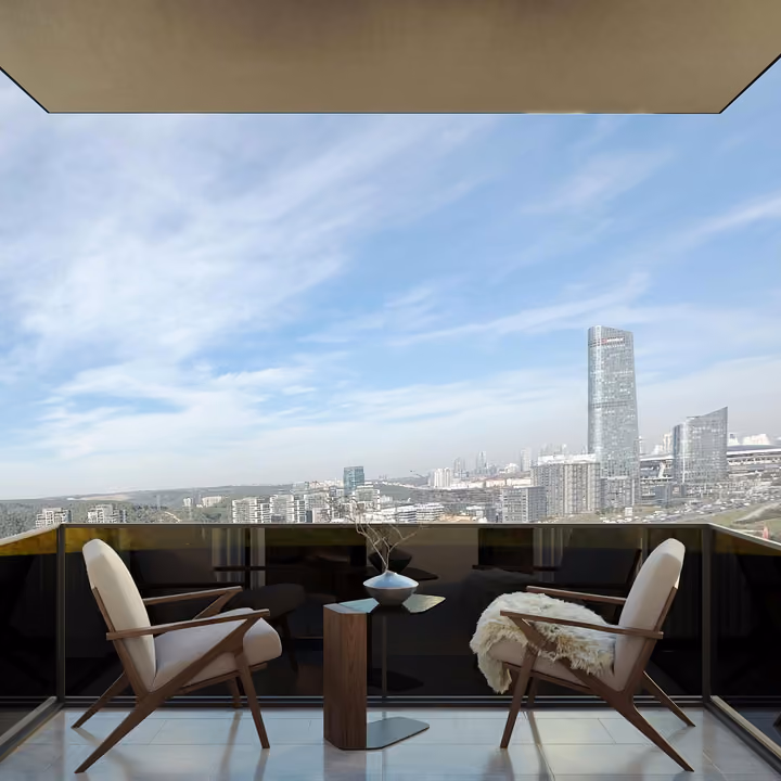 Balcony with two chairs and a table overlooking the city skyline.