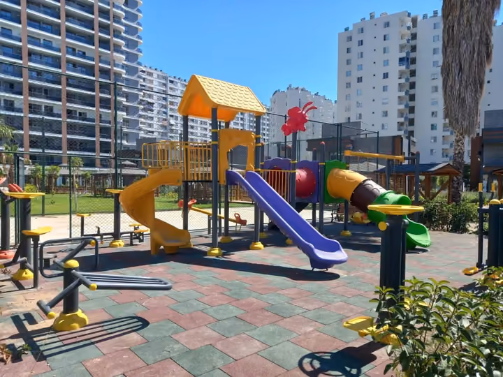 A colorful children playground with slides and climbing equipment.