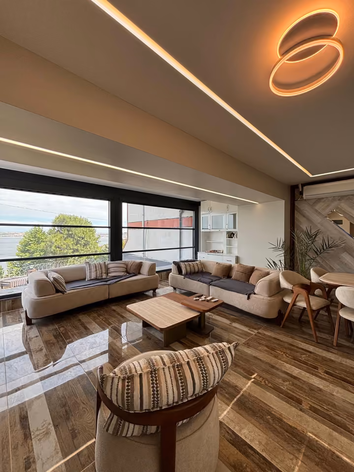 Living room seating area with large windows in the Beylikduzu villa.