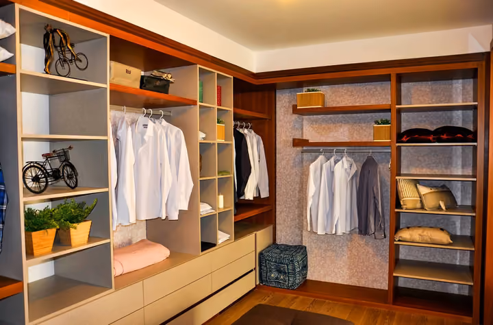 Fitted dressing room with open shelving.