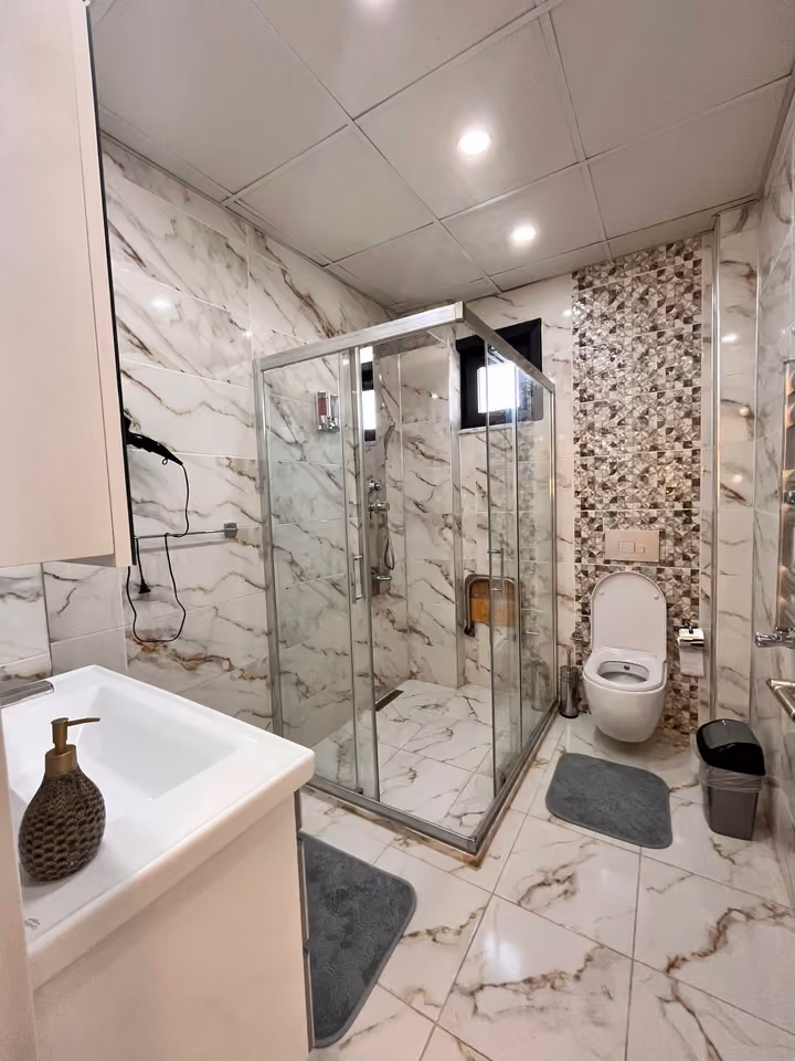 Bathroom shower and toilet in the furnished seafront mansion in Buyukcekmece.