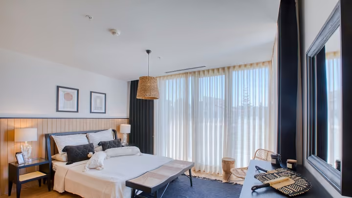 Double bedroom with full height glazed doors in Boyalik, Cesme.