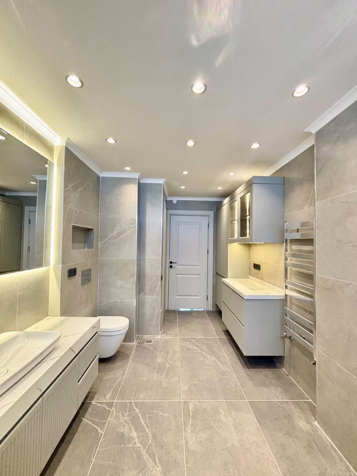 Bathroom showing built-in storage, a vanity and a towel rail.