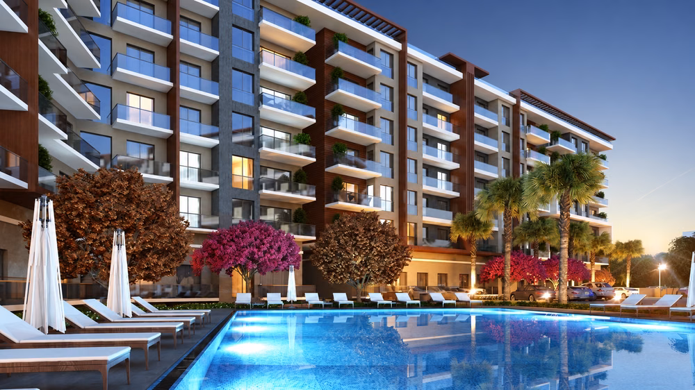 Architectural rendering of the shared outdoor pool, landscaped courtyard and apartment balconies at dusk.