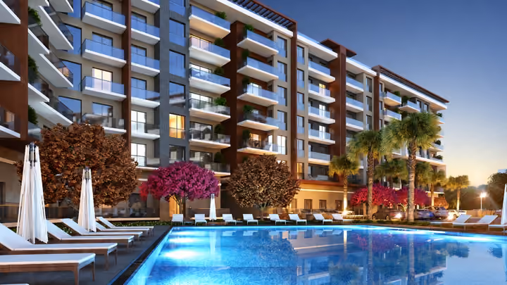 Architectural rendering of the shared outdoor pool, landscaped courtyard and apartment balconies at dusk.