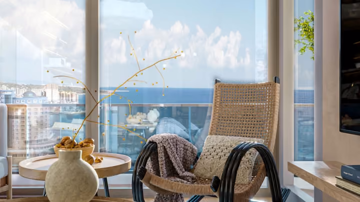 Interior rendering of a lounge chair beside the living room glazing