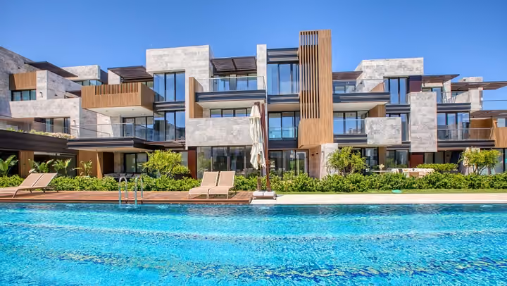 Central apartment facade across the swimming pool in Boyalik, Cesme.
